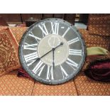 An oversized ornamental wall clock, diameter 90cm