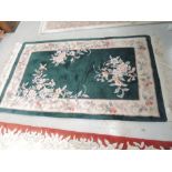 A modern Chinese rug, having green ground, approx 153 x 93cm