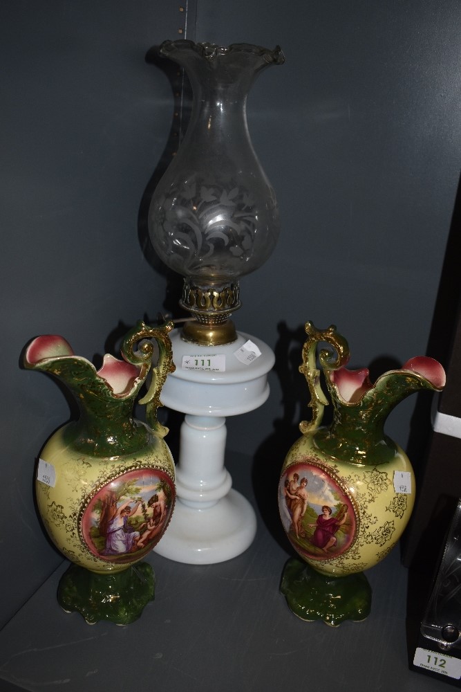 Two ceramic mantel urns and an oil lamp having fluted glass chimney.