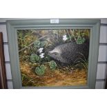 A framed oil on canvas signed Marion Bradley depicting hedgehog and violet.