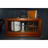 A vintage French Barograph by Richard Freres in a wood and glass case,also included is a book on