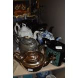 A collection of vintage and antique tea pots, various styles and designs, some attractive designs