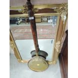 A traditional brass and copper warming pan