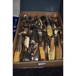 A box full of mixed vintage cutlery, various items and styles.