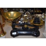 A set of black Libra scales having brass bowls, a selection of weights also included.