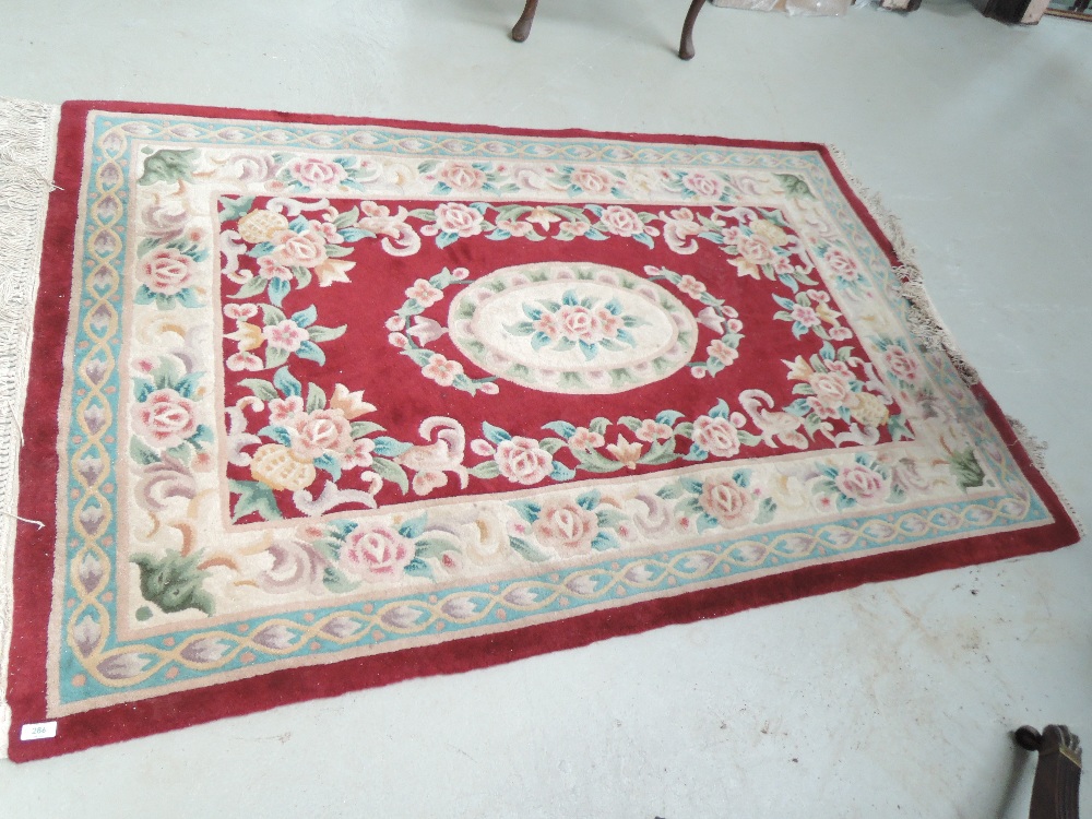 A modern Chinese rug having burgundy ground, approx. 185 x 122cm