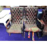 A vintage red leather rocker and similar armchair, both very grubby and worn