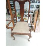 An early 20th Century oak armchair , believed to be Waring and Gillows, approx. Width 55cm