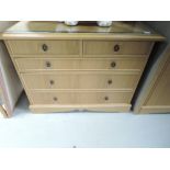 A modern golden oak bedroom chest of two over three drawers , approx. Width 105cm, and a matching