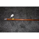 A wooden walking cane or swagger stick having hallmarked silver top.