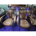 A set of four metal work and leather dining armchairs, of stylised form