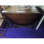 A mid 20th Century oak twist gateleg dining table, approx. closed width 105cm