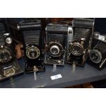 Five folding cameras. A Kodak No1A Autograph Jr, Kodak Folding Brownie Six-20, an Ensign Prontor, an