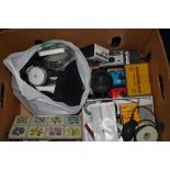 A box of photographic equipment including cameras, filters, paper etc
