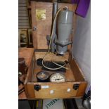 An Ilford enlarger on wooden case with dark room clock