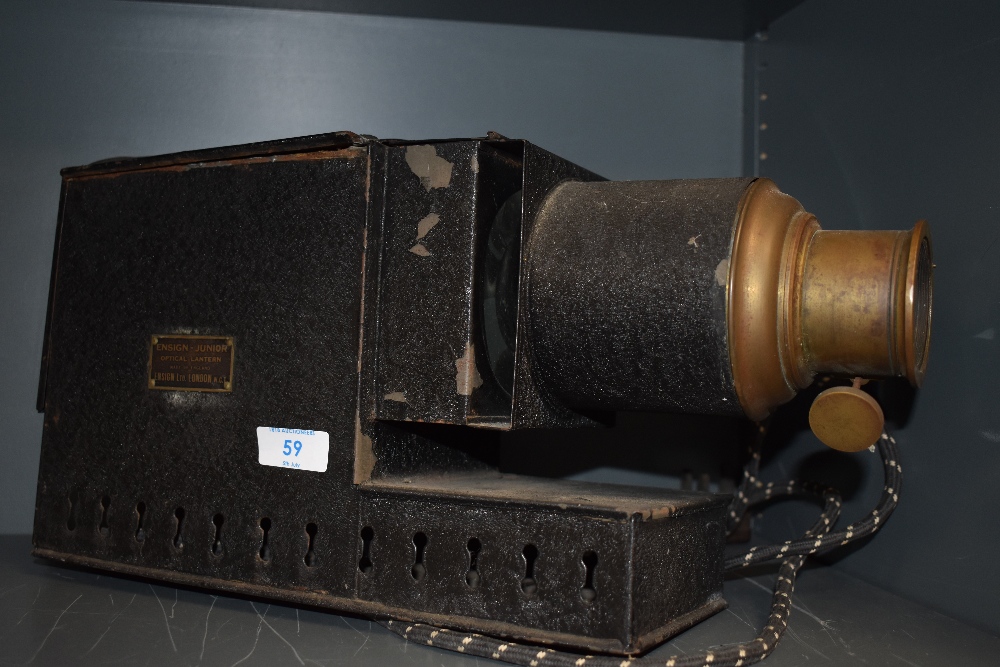 An Ensign Junior electric magic lantern and a box of slides