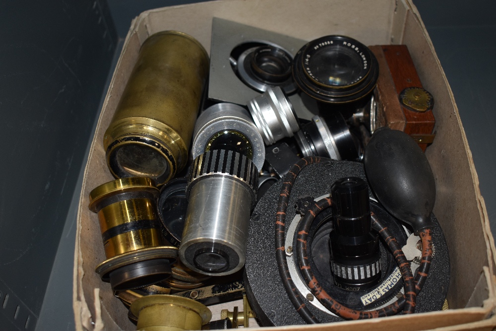 A box of various lenses and camera parts