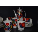 A retro coffee set having a bold bright floral pattern, included are milk jug, lidded sugar pot