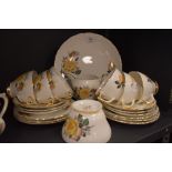 A vintage Delphine bone china part tea set, containing cups and saucers, milk jug and sugar basin,