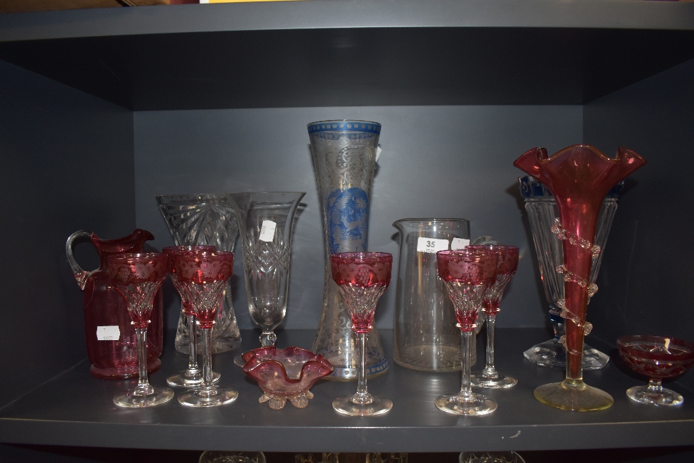 A mixed lot of glass, including etched cranberry glasses,jugs ,vases accented with blue and