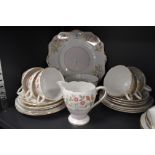 A part tea set Having floral transfer pattern in pastel colours and gilt edging, includes cake plate