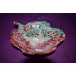 A Murano glass dish in pink and blue tones.