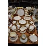 A part Duchess bone china 'Winchester' dinner service having deep red and gilt pattern to edges,