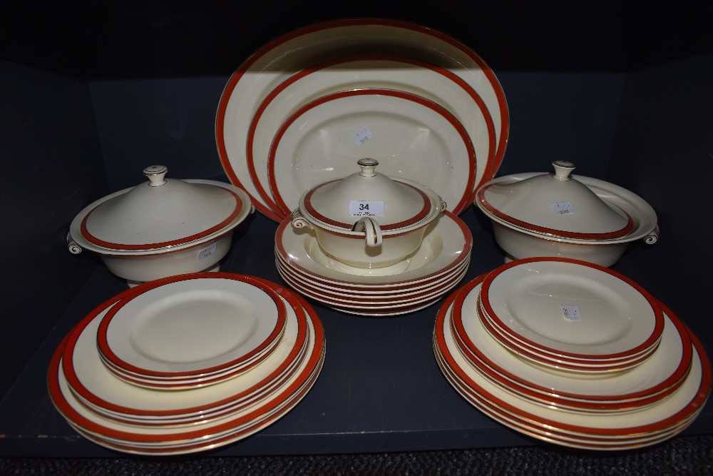 A vintage Mintons part dinner service, having red borders and gilt edging, included are tureens; one