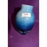 A Caithness glass vase in blue, white and black hues.