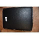 A black leather effect travel watch case having apertures for eight watches