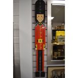 A childrens wall mounted Queens guard height chart.