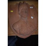 A wall mounted 3-D terracotta plaque depicting queen Mary.