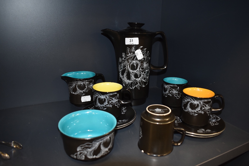 A vintage Crown Devon Harlequin part coffee set in black with white transfer pattern of fruits and