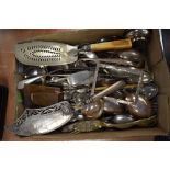 A large selection of mixed flatware, including decorative fish servers.