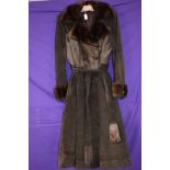 A ladies vintage brown suede coat having belted waist and pockets to front and button fastening,