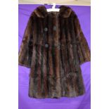 A vintage 1950s/1960s glossy dark brown mink coat having pockets to sides and large cord detailed