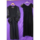 Two black 1930s dresses, one in velvet with contrasting iridescent fabric to underside of sleeves