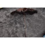 A beautiful antique parasol in brown silk with fringed edging, having wooden handle, in surprisingly