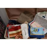 A suitcase containing various vintage and modern scarves, including two floral 'Echo' silk scarves