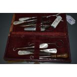 A Late 19th century manicure set containing scissors , button hooks and similar, five items having