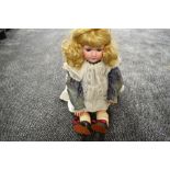 An early 20th century Armand Marseille bisque headed doll having sleep eyes, open mouth with four