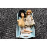 An early 20th century Petite Francaise J Verlingue (anchor) bisque headed doll having fixed eyes and