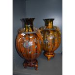 A pair of oriental possibly Japanese mantle vase or urns with three footed base and character seal