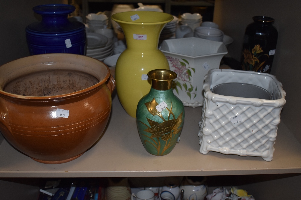 A variety of vases and planters, different styles and shapes.