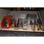 A selection of masonry and similar building tools including trowls and chisels