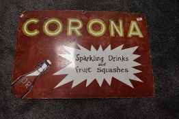 A vintage enamel advertising sign for Corona Sparkling drinks and fruit squashes