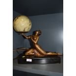 An Art Deco lamp with semi nude female figure and mottled glass dome with black marble base