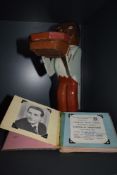A vintage wooden character holding a tray and an Autograph book, film star interest and Morecambe