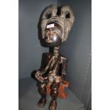 An Ethnic tribal fertility figure probably of African descent possibly Bangwa Anyi in hand carved