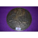 A brass cast Chinese mirror back top, bearing charcter marks and depicting cranes in flight and